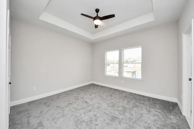 a view of empty room with ceiling fan