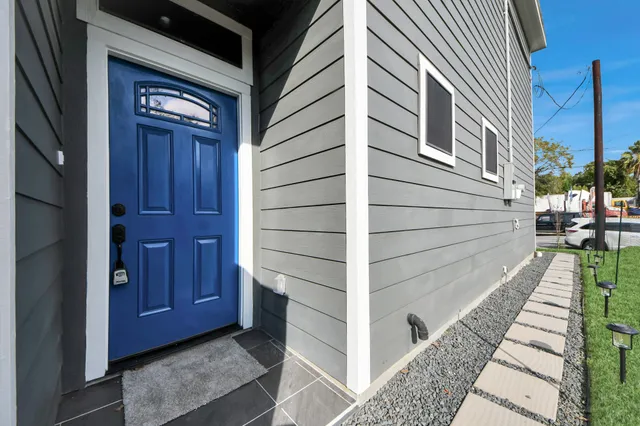 a view of a house with a door and wooden walls