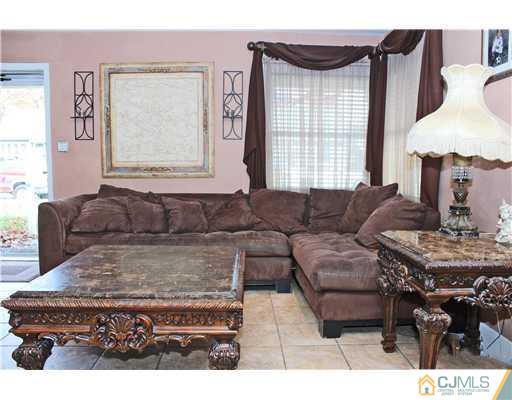 21 Brookville Road Edison, NJ 08817 - Photo 2 of 25 a living room with furniture and a large window