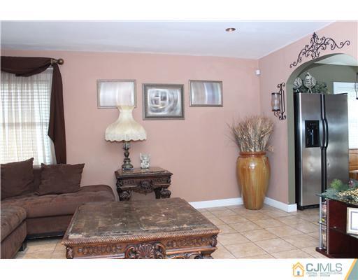 21 Brookville Road Edison, NJ 08817 - Photo 12 of 25 a living room with furniture and a chandelier