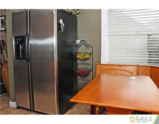 21 Brookville Road Edison, NJ 08817 - Photo 15 of 25 a room with water heater and wooden cabinets