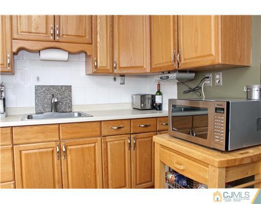 21 Brookville Road Edison, NJ 08817 - Photo 16 of 25 a kitchen with stainless steel appliances granite countertop a refrigerator oven stove and white cabinets
