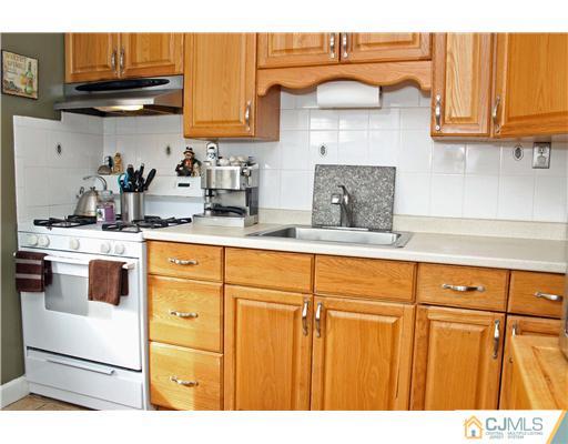 21 Brookville Road Edison, NJ 08817 - Photo 17 of 25 a kitchen with stainless steel appliances granite countertop a sink and cabinets