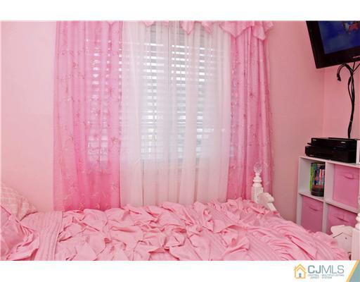 21 Brookville Road Edison, NJ 08817 - Photo 19 of 25 a view of a bedroom with a bed and a chair