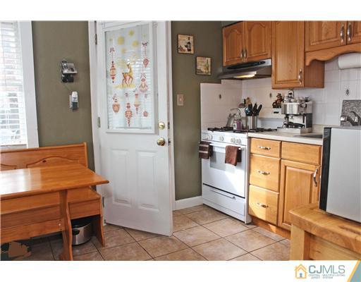 21 Brookville Road Edison, NJ 08817 - Photo 3 of 25 a kitchen with stainless steel appliances granite countertop a refrigerator and a stove top oven
