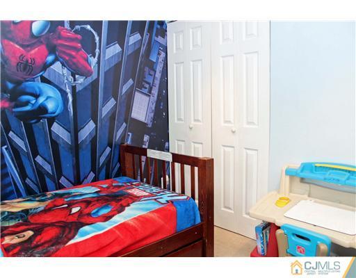 21 Brookville Road Edison, NJ 08817 - Photo 21 of 25 a bedroom with a bed and a lamp with the dresser