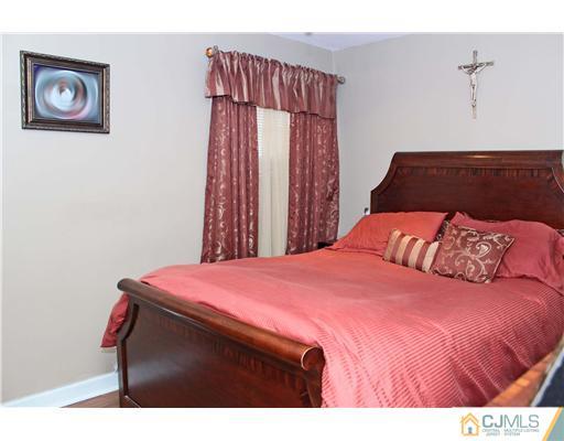 21 Brookville Road Edison, NJ 08817 - Photo 4 of 25 a bedroom with a bed and a dresser
