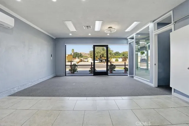 a living room with furniture and large windows