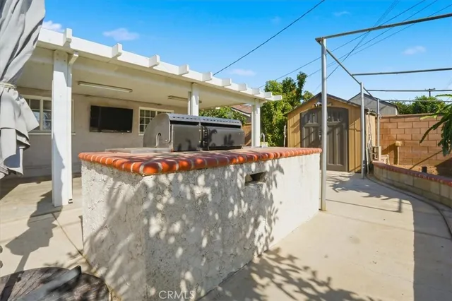 a kitchen with a stove and a potted plant