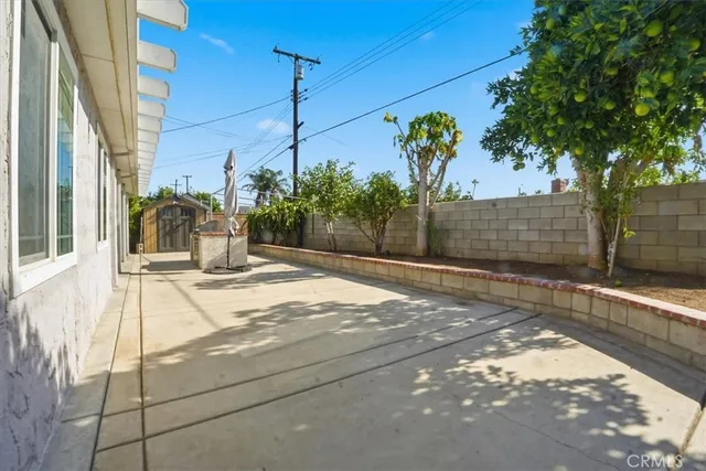 a view of a street with potted plants