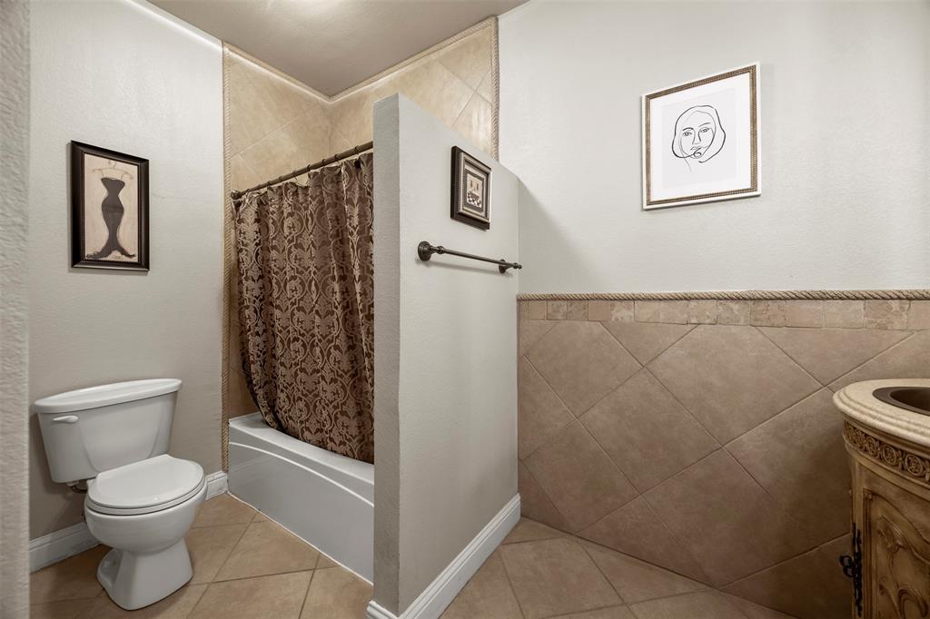 219 Mohundro Road Ferris, TX 75125 - Photo 31 of 40 a bathroom with a toilet and a shower