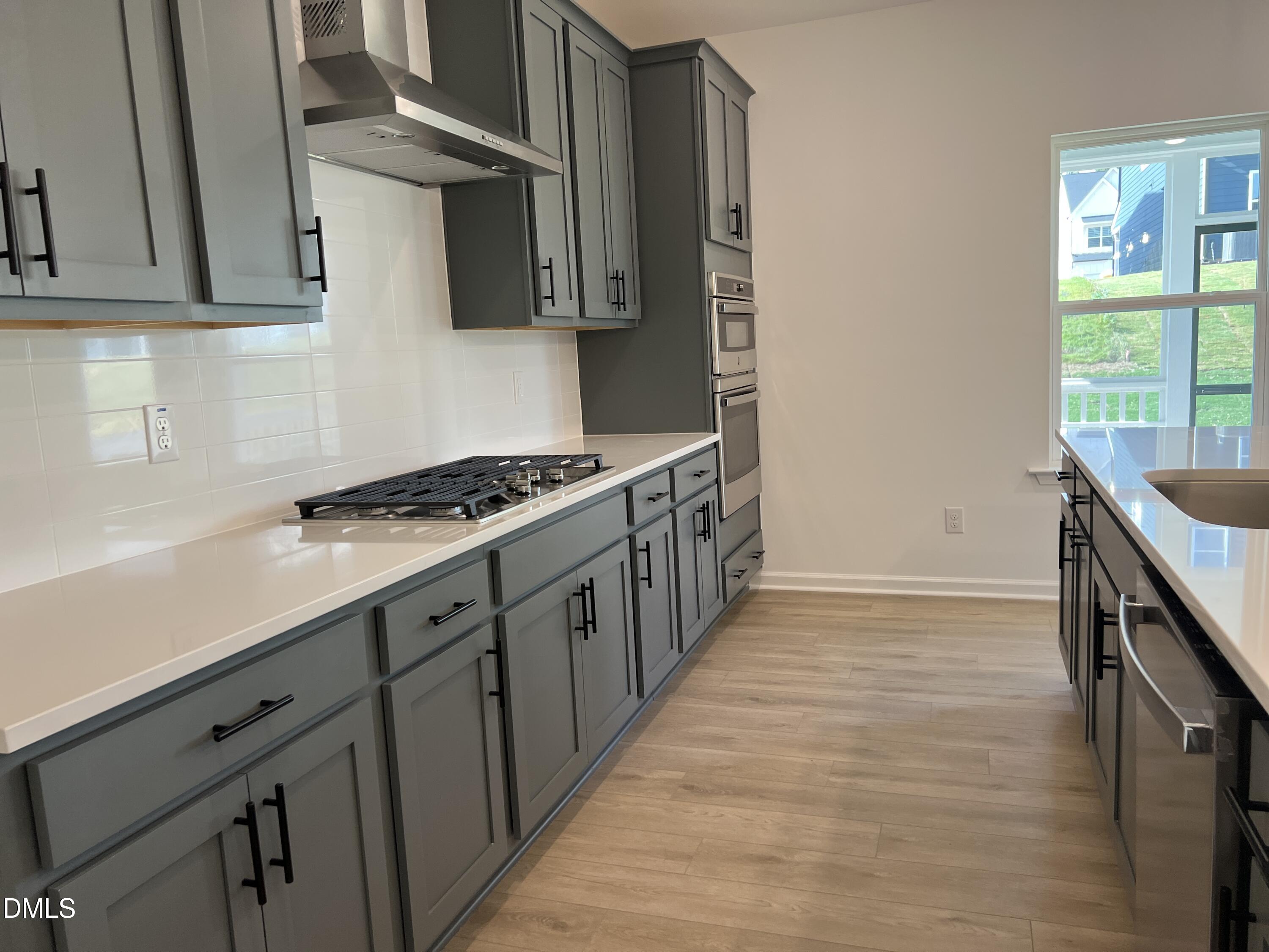 4305 Darius Lane, Unit 27 Willow Spring, NC 27592 - Photo 11 of 18 a kitchen with granite countertop a stove and a sink