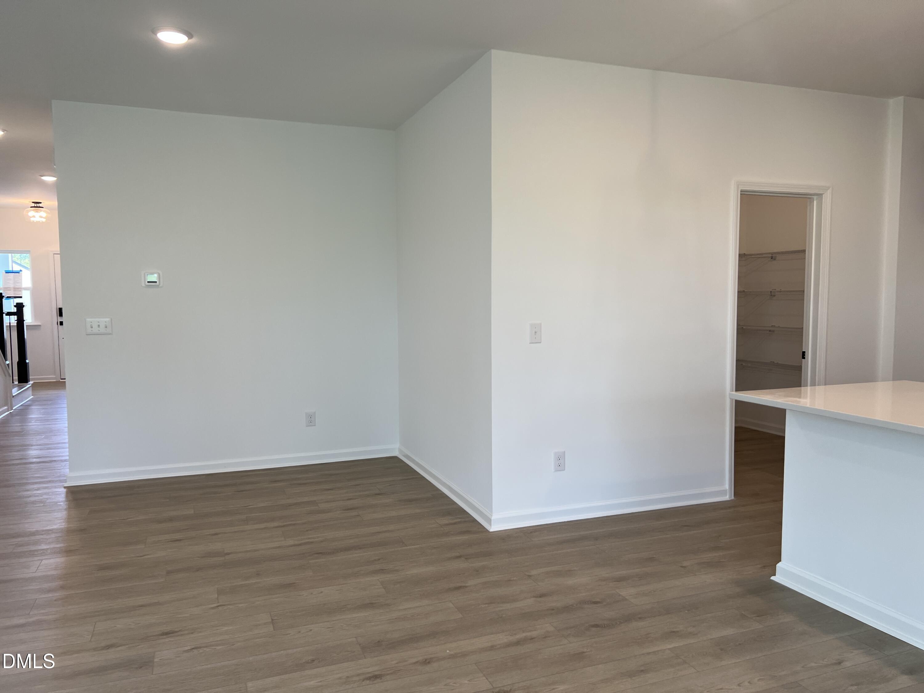 4305 Darius Lane, Unit 27 Willow Spring, NC 27592 - Photo 13 of 18 a view of an empty room with wooden floor and a bathroom