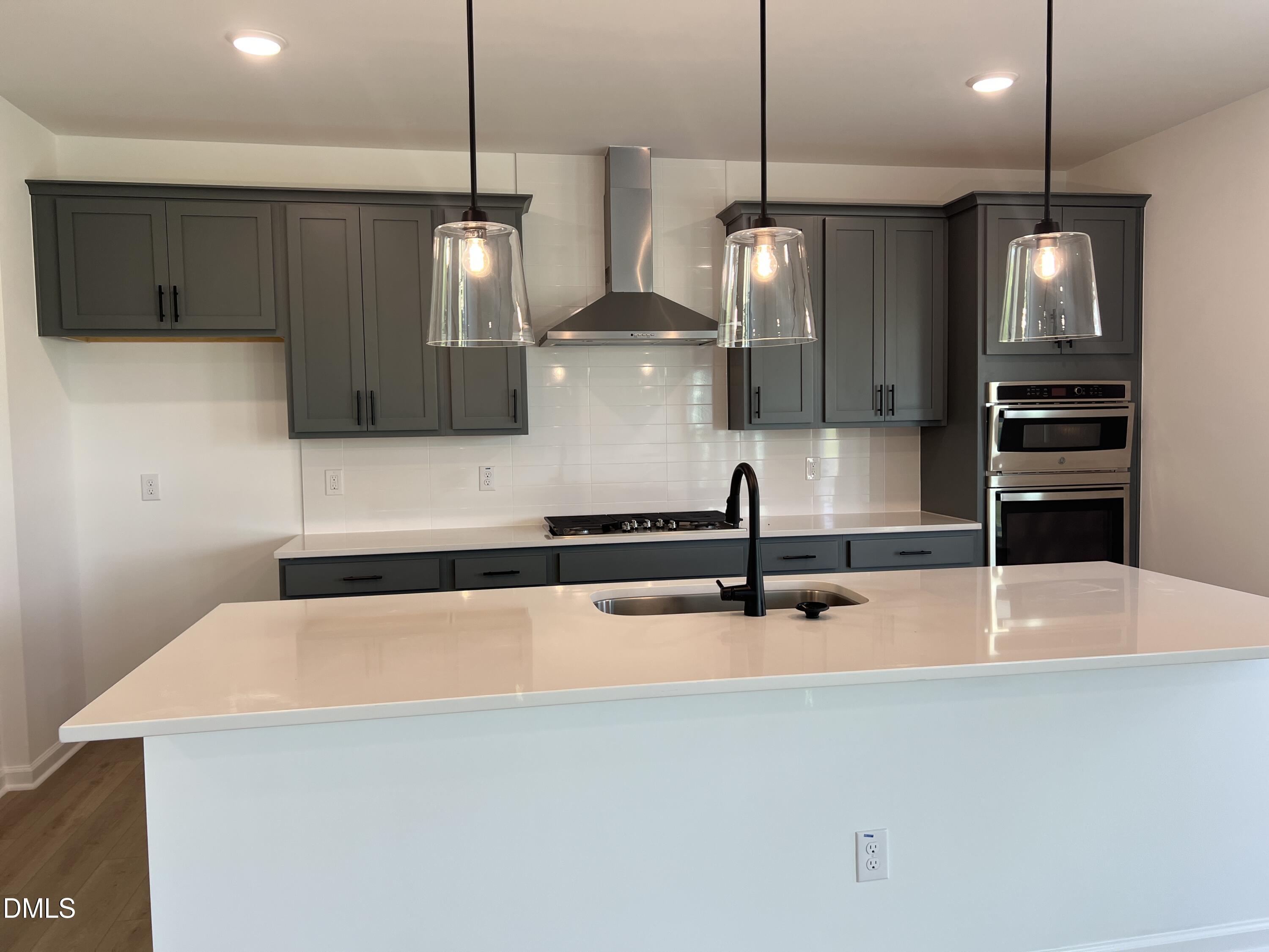4305 Darius Lane, Unit 27 Willow Spring, NC 27592 - Photo 6 of 18 a kitchen with stainless steel appliances a refrigerator a sink and a stove
