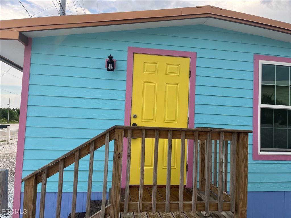 4874 Pine Island Road, Unit C St. James City, FL 33956 - Photo 1 of 14 a front view of a house with a garage
