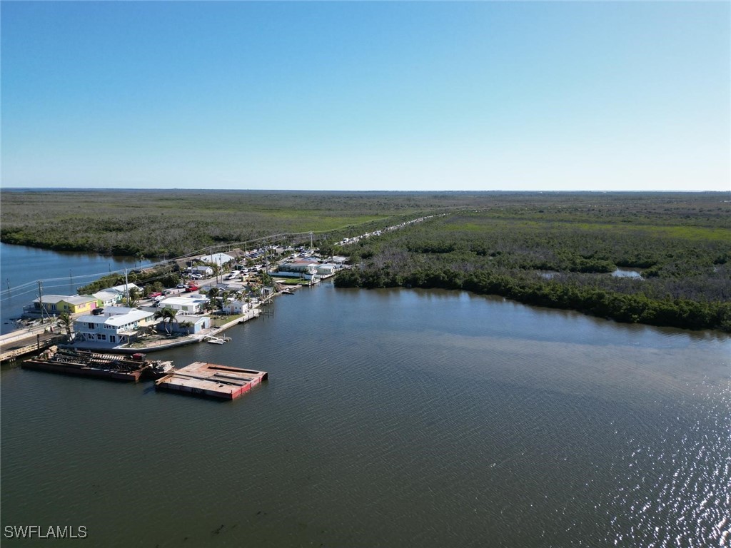 4874 Pine Island Road, Unit C St. James City, FL 33956 - Photo 12 of 14 a view of a lake with boats and trees in the background