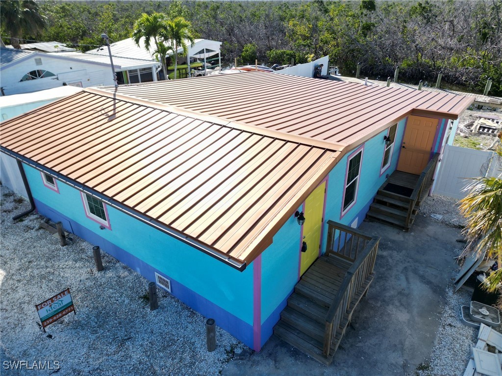 4874 Pine Island Road, Unit C St. James City, FL 33956 - Photo 2 of 14 a view of a terrace with a wooden floor
