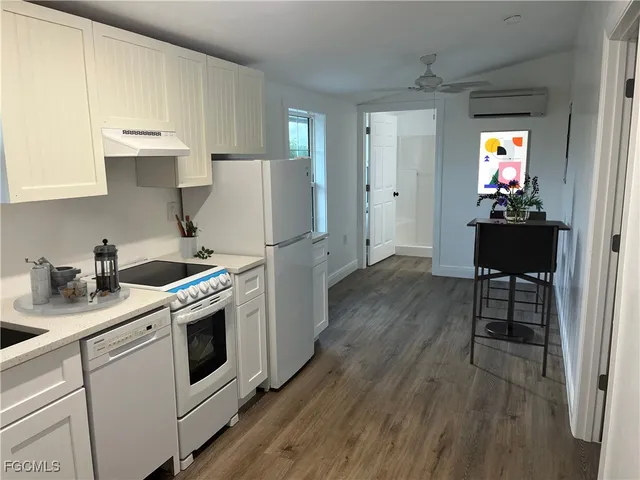 a kitchen with a sink a stove a refrigerator and cabinets