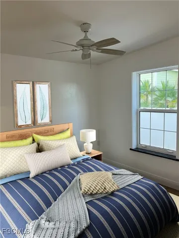 a bedroom with a bed and window