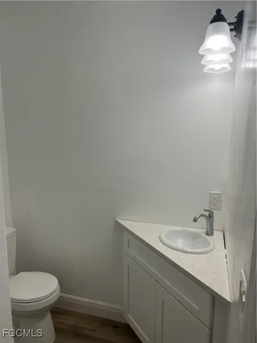 a bathroom with a sink toilet and a mirror