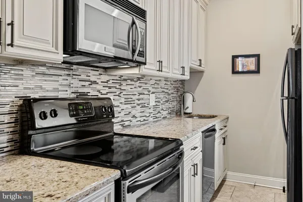 a kitchen with a stove and a microwave