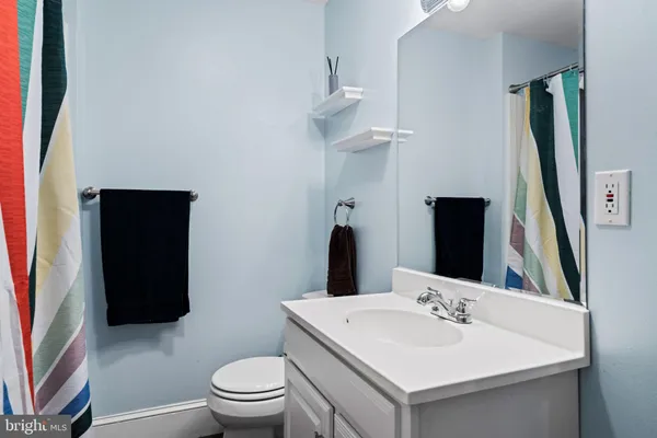 a en suite bathroom with a toilet sink and mirror