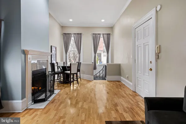 a spacious bedroom with a bed and wooden floor