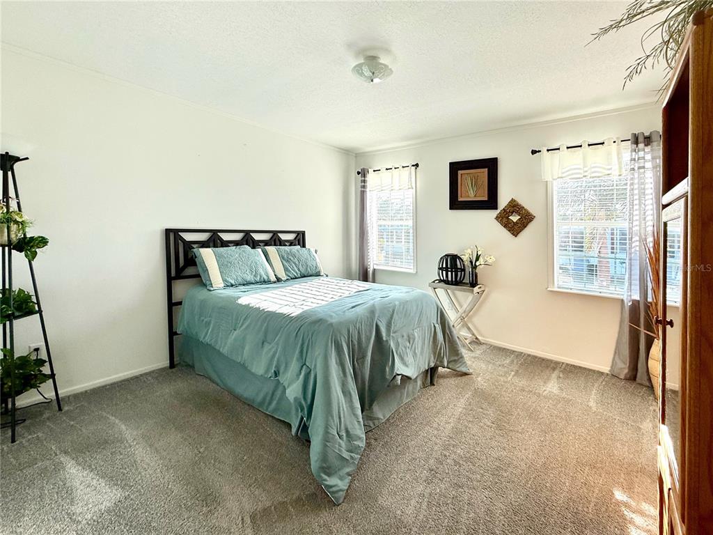 101 St Johns Way West Apollo Beach, FL 33572 - Photo 6 of 24 a bedroom with a bed and large windows