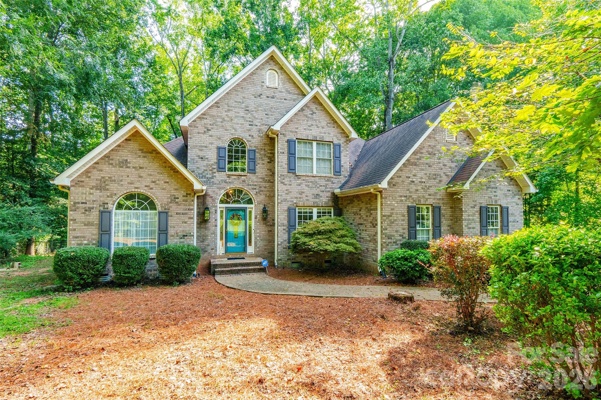 321 Forbes Court Clover, SC 29710 - Photo 31 of 31 a view of a yard in front of a house with plants and large trees