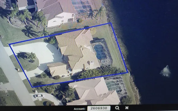 an aerial view of a house with a yard and a painting