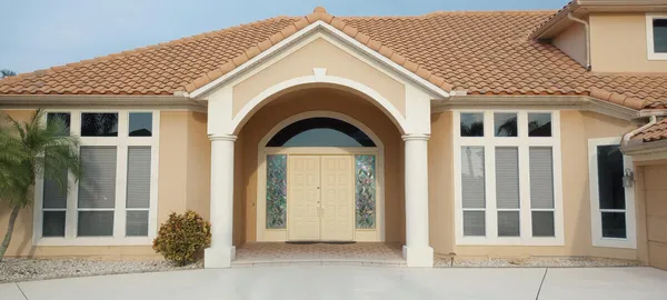 a view of a house with large windows