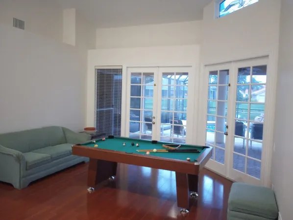 a living room with pool furniture