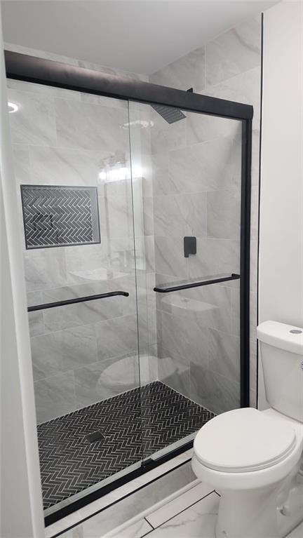 2084 Snow Road Southwest Atlanta, GA 30311 - Photo 51 of 53 a bathroom with a toilet and a shower