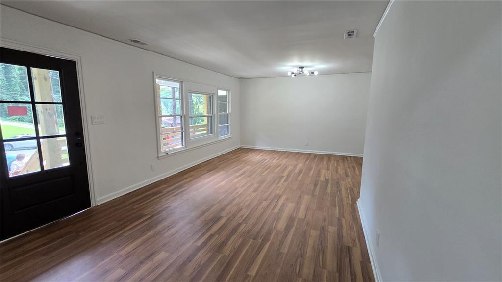 2084 Snow Road Southwest Atlanta, GA 30311 - Photo 8 of 53 wooden floor in an empty room with a window