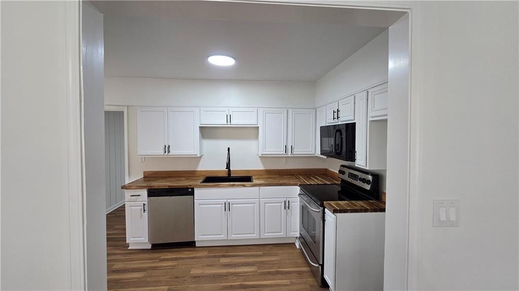 2084 Snow Road Southwest Atlanta, GA 30311 - Photo 10 of 53 a kitchen with stainless steel appliances a sink stove and refrigerator