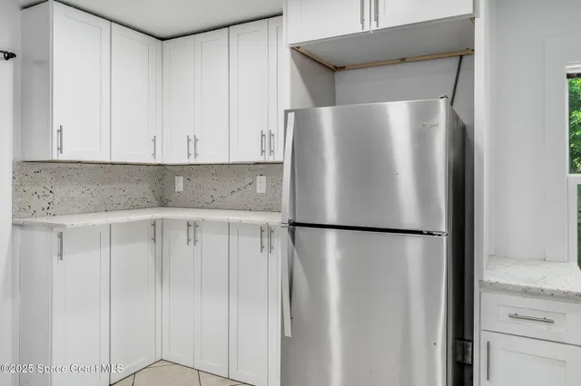 a white refrigerator freezer sitting in a kitchen