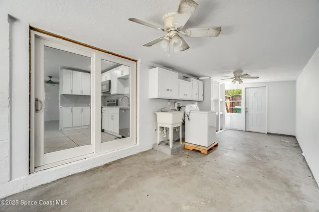 a view of a kitchen with refrigerator and a ceiling fan