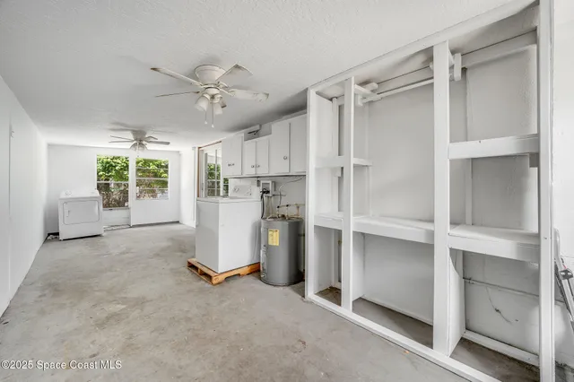 a view of a kitchen with refrigerator and ceiling fan