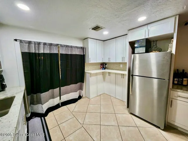 a kitchen with stainless steel appliances a refrigerator sink and cabinets