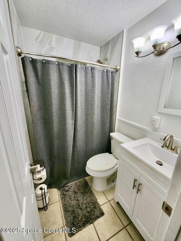 1228 East Azalea Court Melbourne, FL 32935 - Photo 4 of 18 a bathroom with a sink toilet and shower