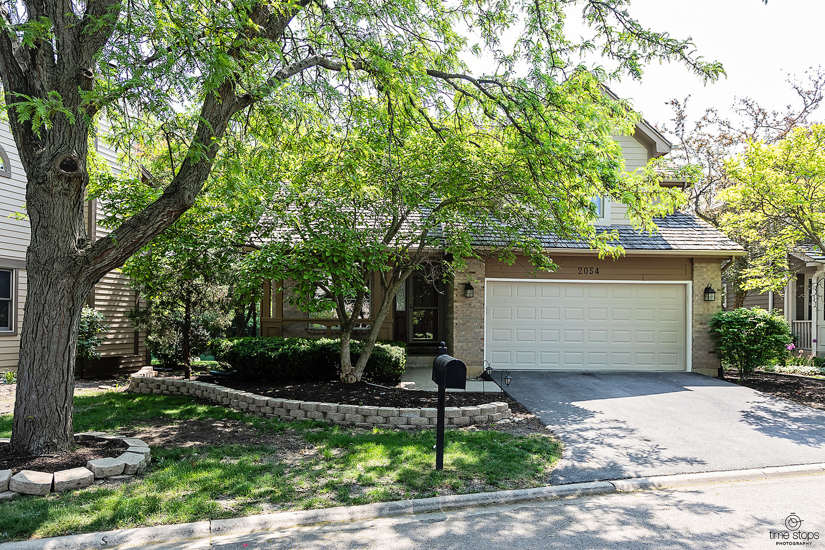 2054 Brookside Lane Aurora, IL 60502 - Photo 2 of 39 a front view of a house with a yard and garage