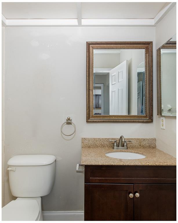 7900 Hardwick Drive, Unit 827 New Port Richey, FL 34653 - Photo 18 of 27 a bathroom with a toilet a sink and mirror