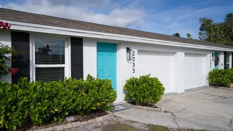 a front view of house and flowers