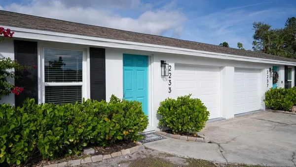 a front view of house and flowers