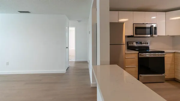 a kitchen with stainless steel appliances a refrigerator and a sink