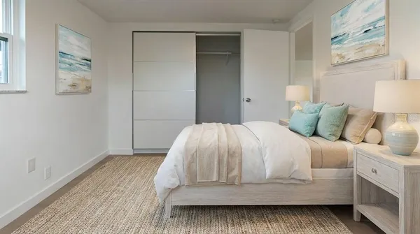 a bedroom with a bed and window