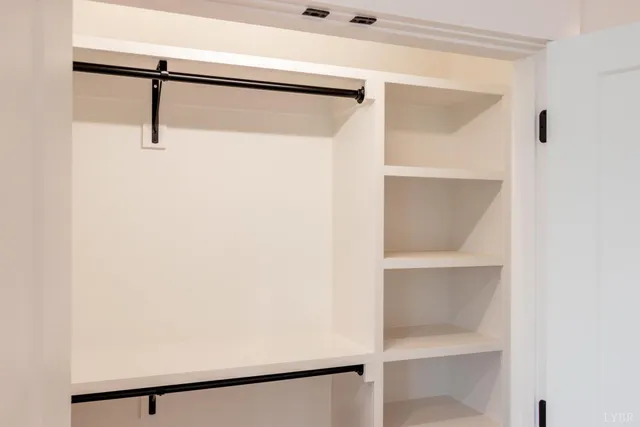 a bathroom with a double vanity sink toilet and a mirror