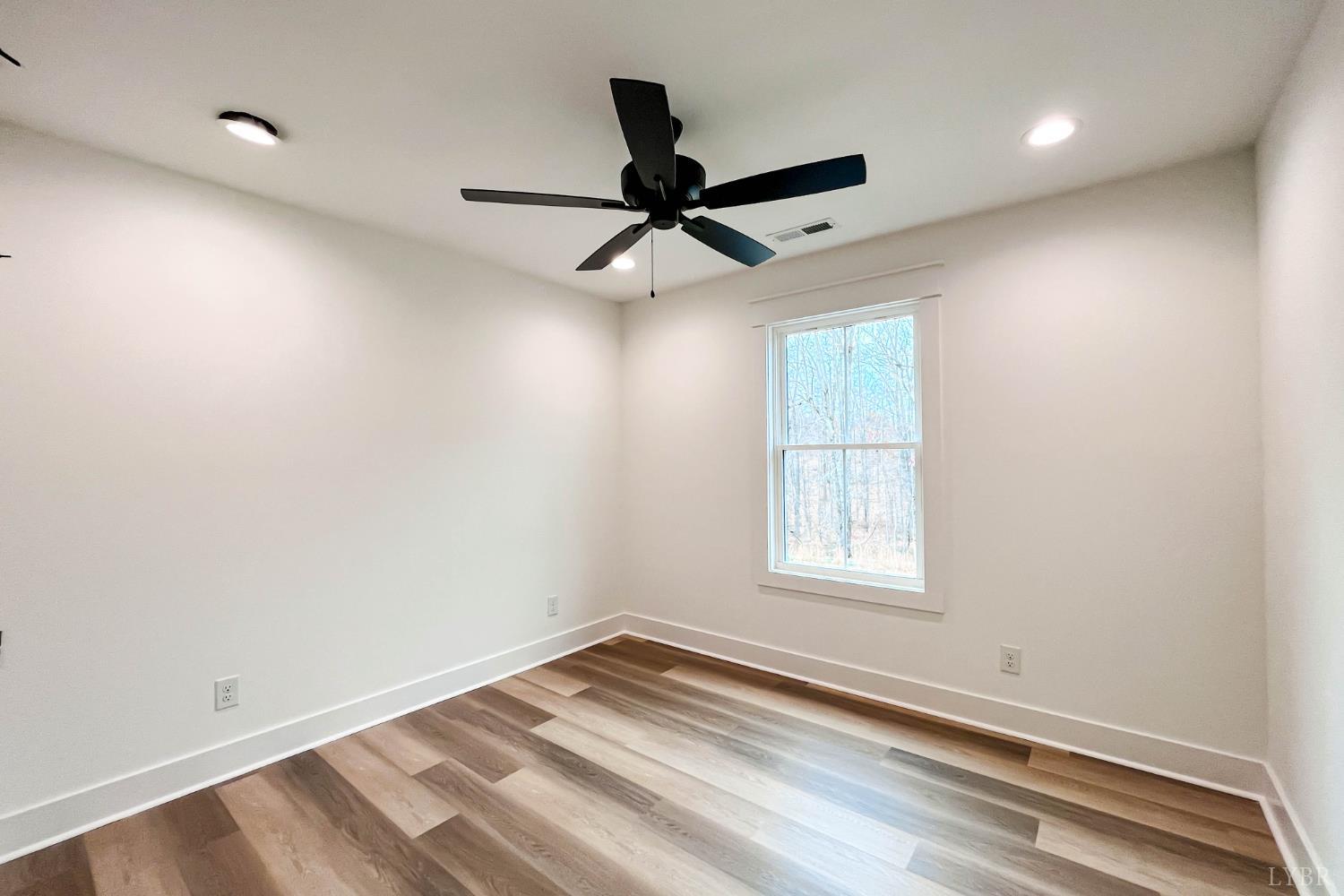 169 Luke Court Rustburg, VA 24588 - Photo 40 of 47 an empty room with a window and a ceiling fan