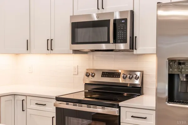 a kitchen with a sink a refrigerator and window