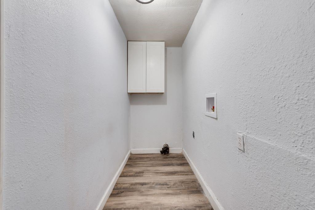 5201 Santa Rosa Drive Haltom City, TX 76117 - Photo 14 of 25 a view of a hallway with wooden floor and a bathroom